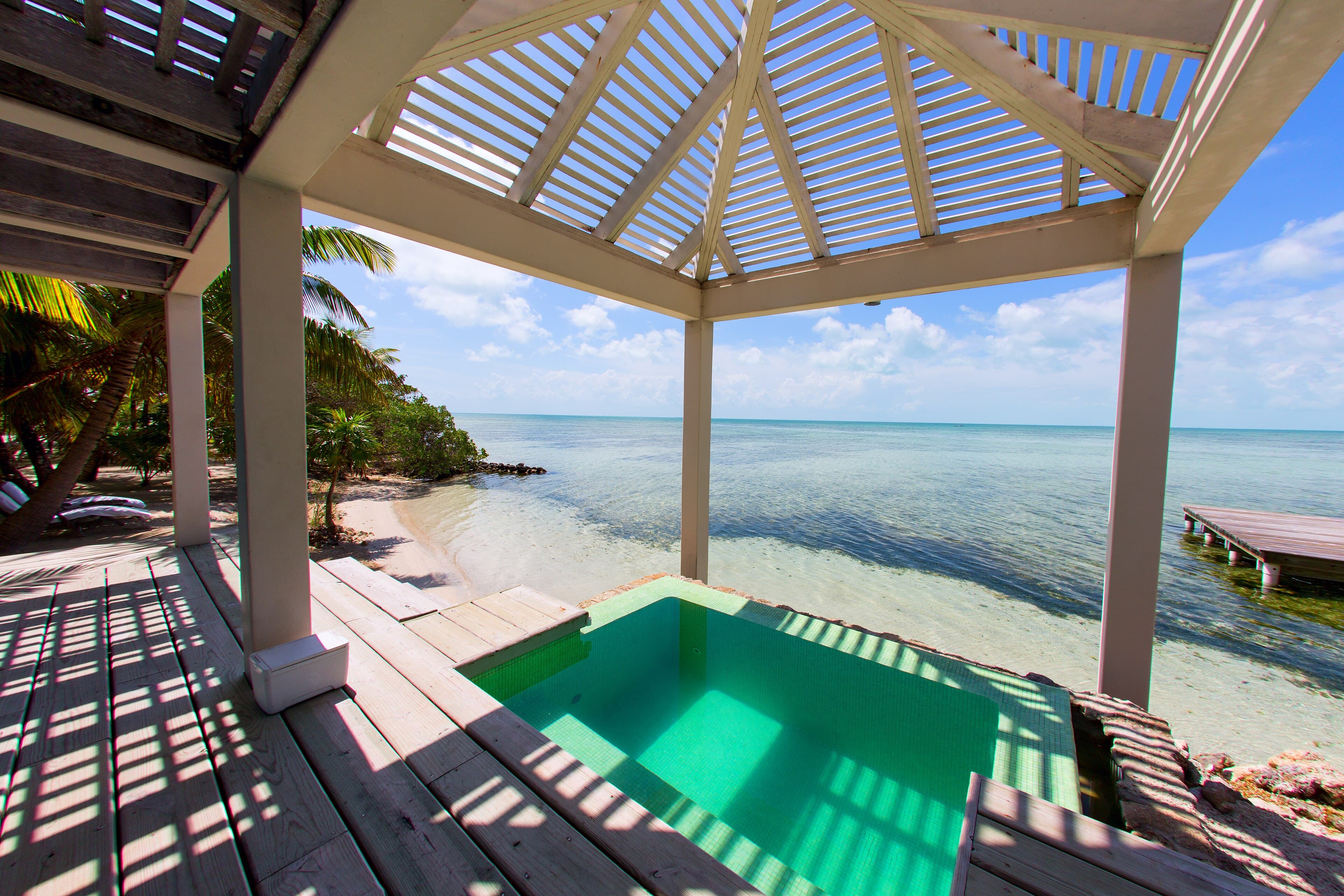 An infinity plunge pool overlooking the sea at a private-island resort.