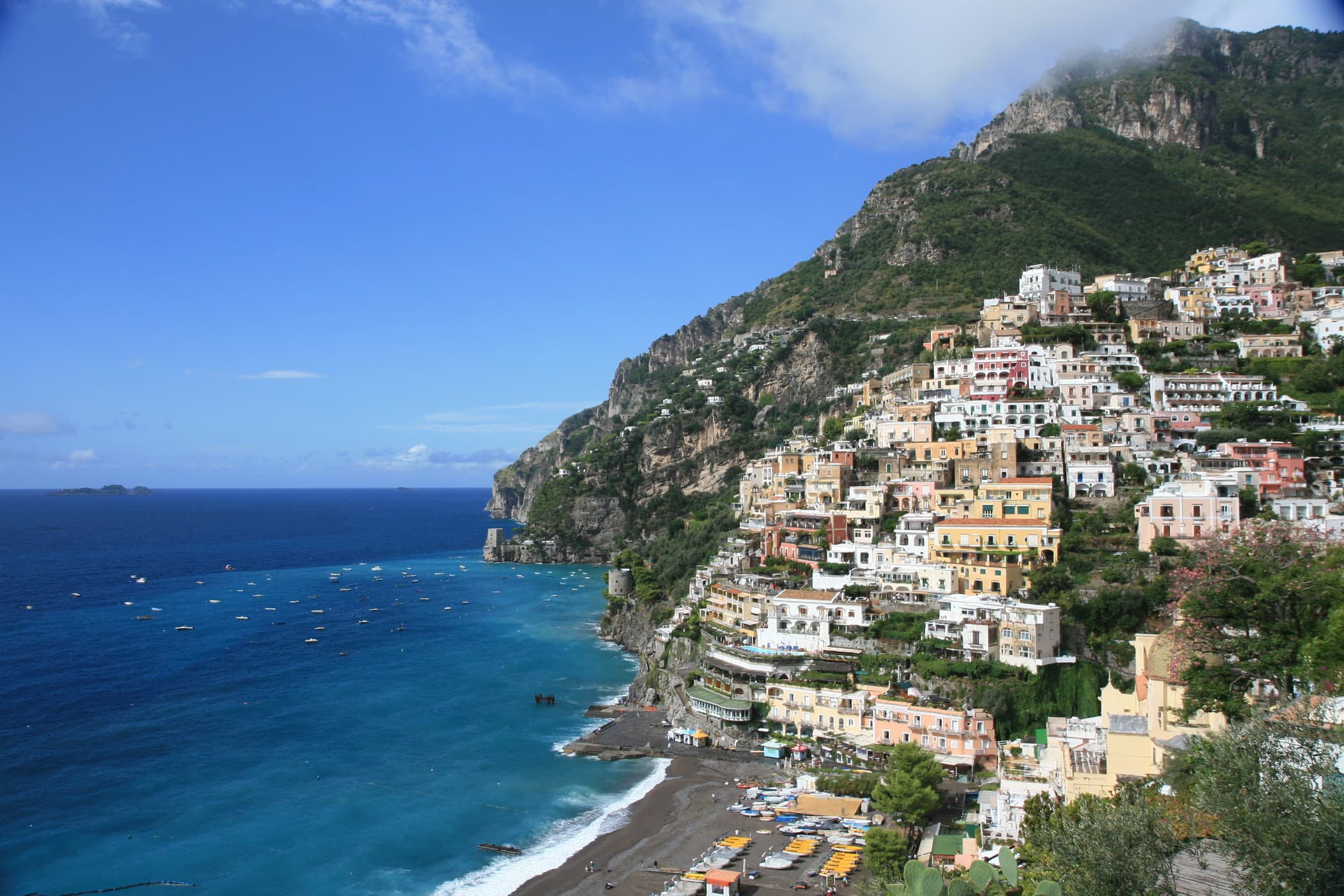 Pastel houses stacked above the beach at Positano on the Amalfi Coast.